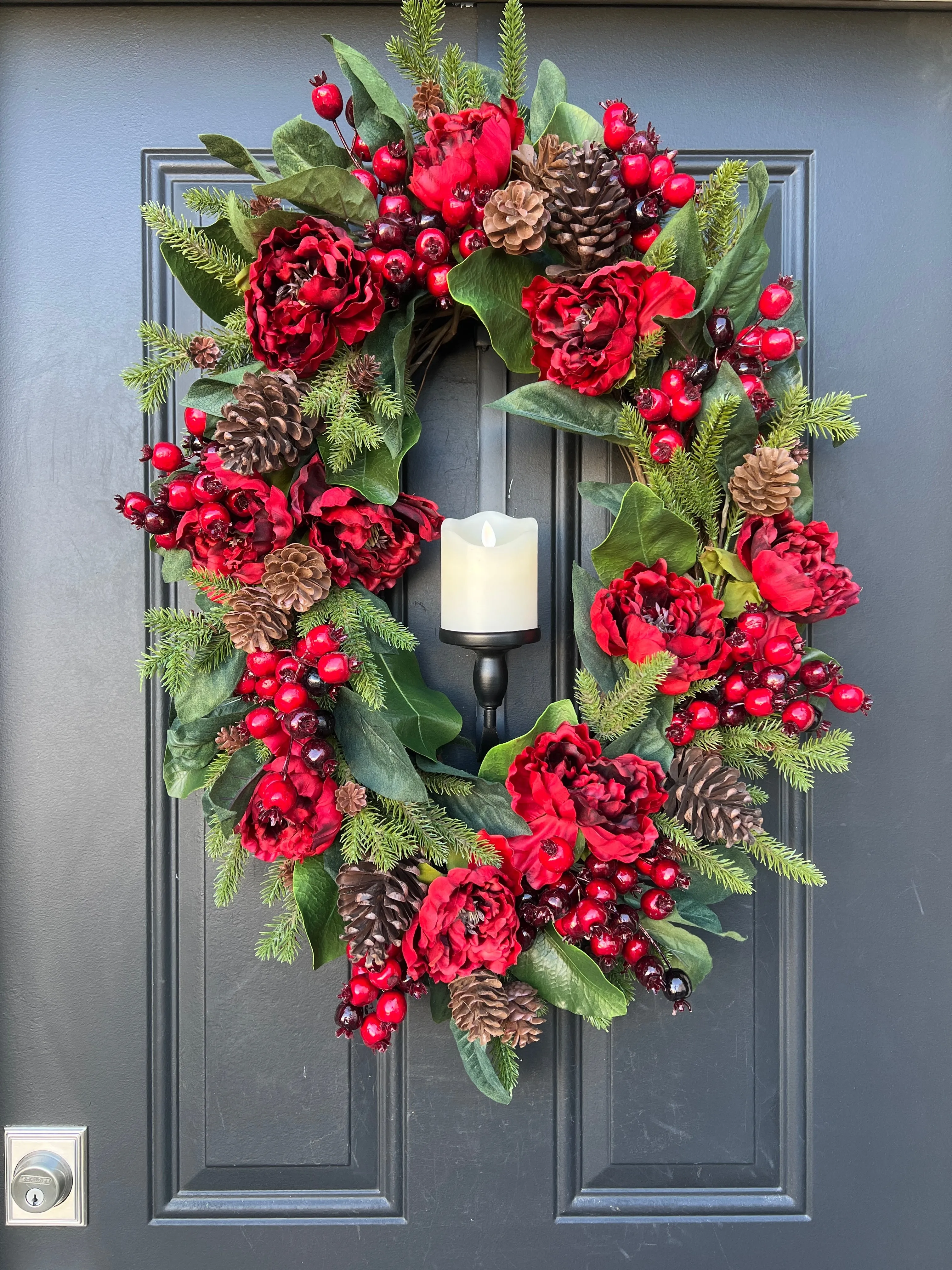 Oval Red and Green Christmas Wreath with Pinecones and Flickering Candle